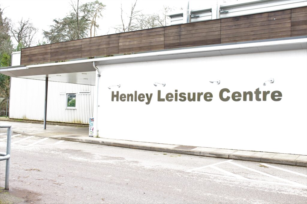 Sincgle storey white wall front of leisure centre with the name Henley Leisure Centre