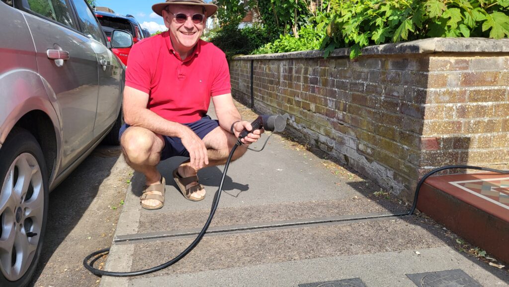 Guy Hargreaves demonstrates an EV gully and charging cable