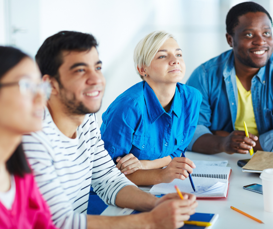 A group of adults sat at a table learning