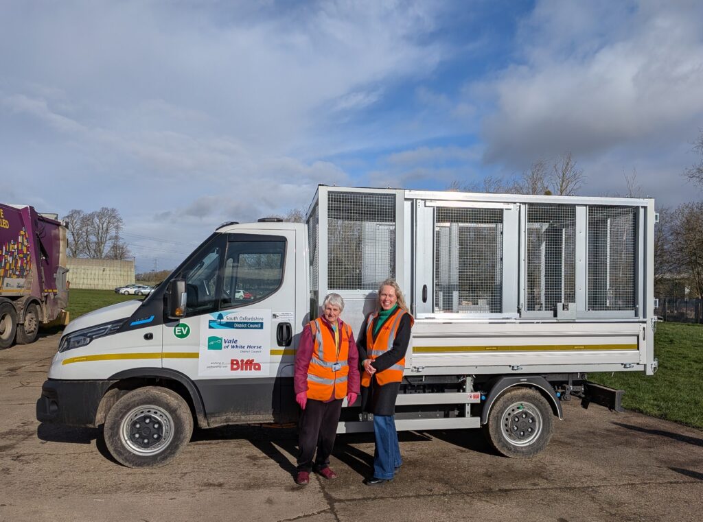 Councillors Sue Cooper and Anne-Marie Simpson stand in front of a new white EV tipper truck