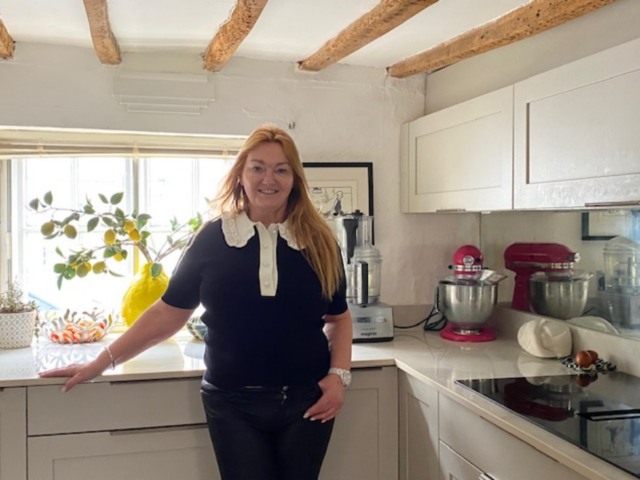 Ms McLean stands in the kitchen in the home she has transformed