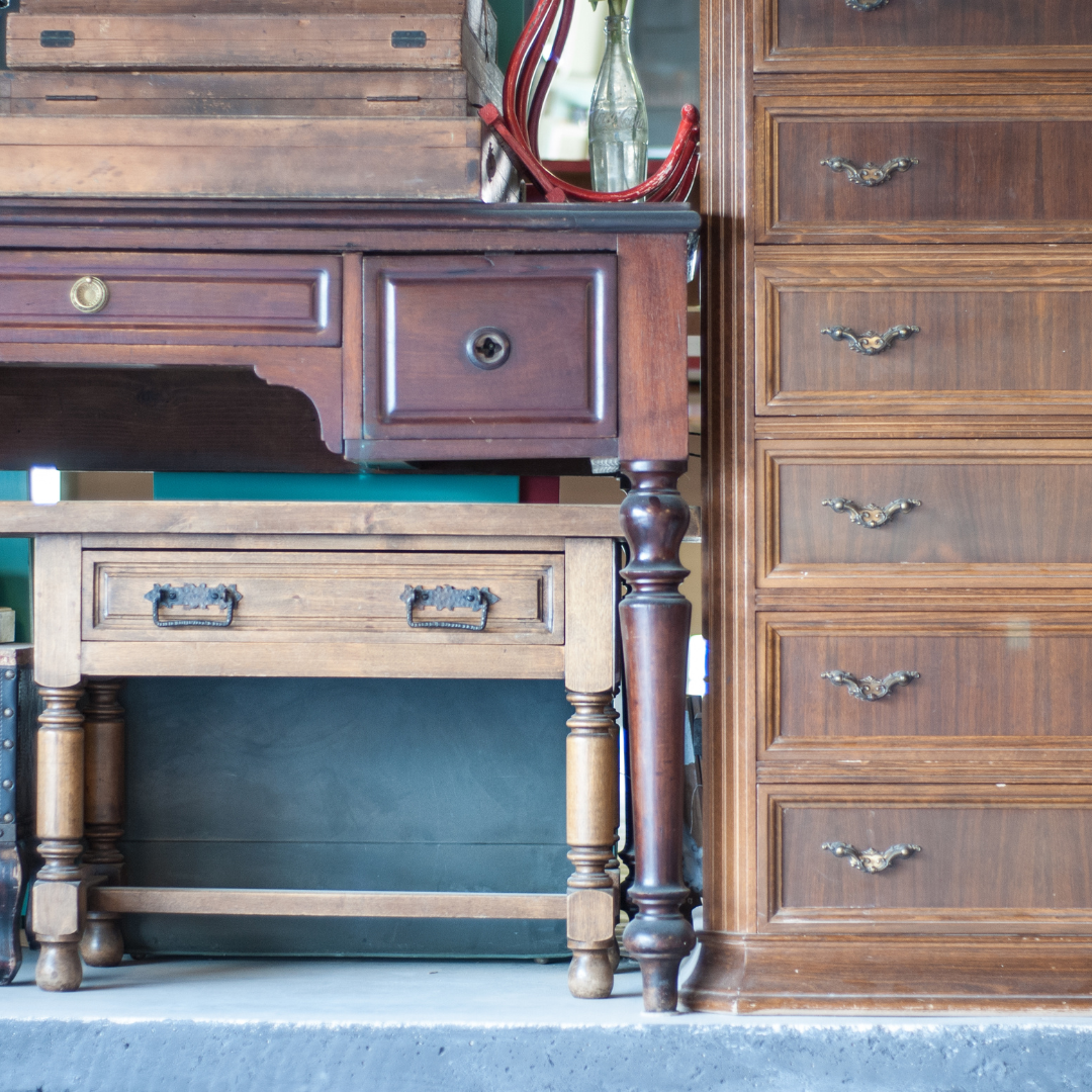 Old tables, chests of drawers, and cabinets stacked on top of each other