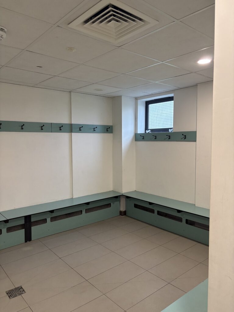 empty chnaging rooms wirth pale green and cream interior