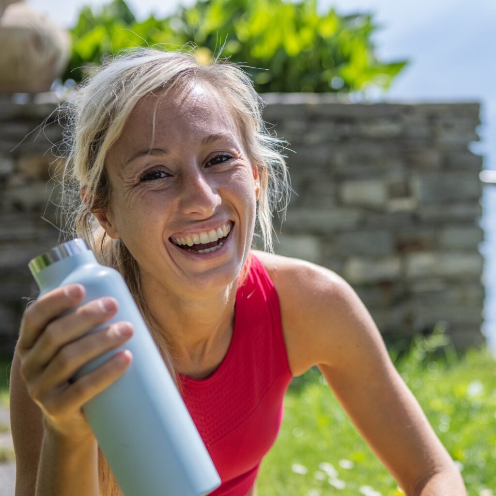 A lady holding a refillable water bottle
