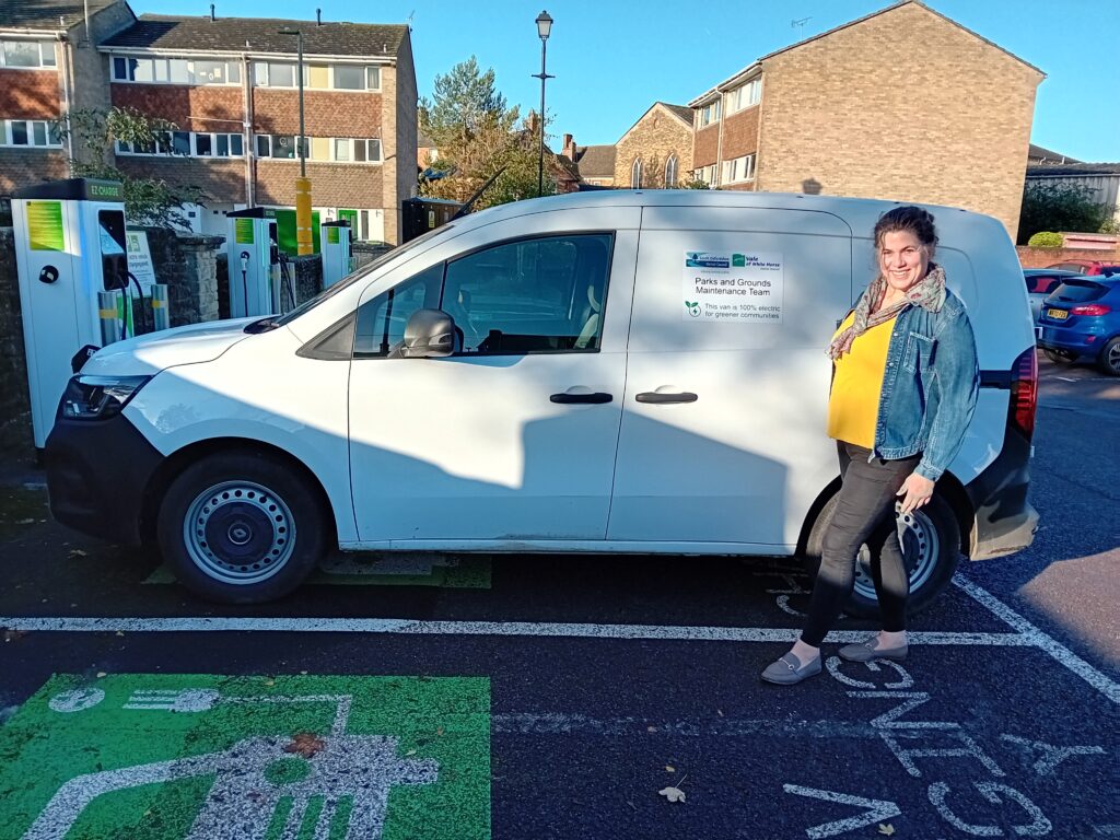 Cllr Bethia Thomas standing in front of an EV van in a car park