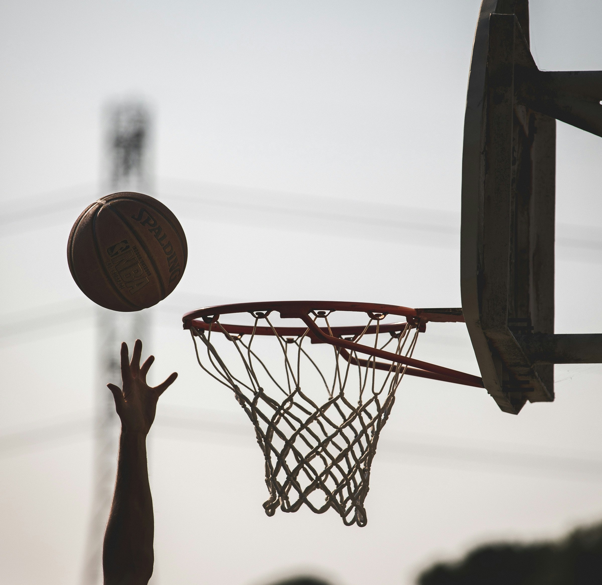 Photo of someone playing basketball. Photo by Tom Briskey on Unsplash