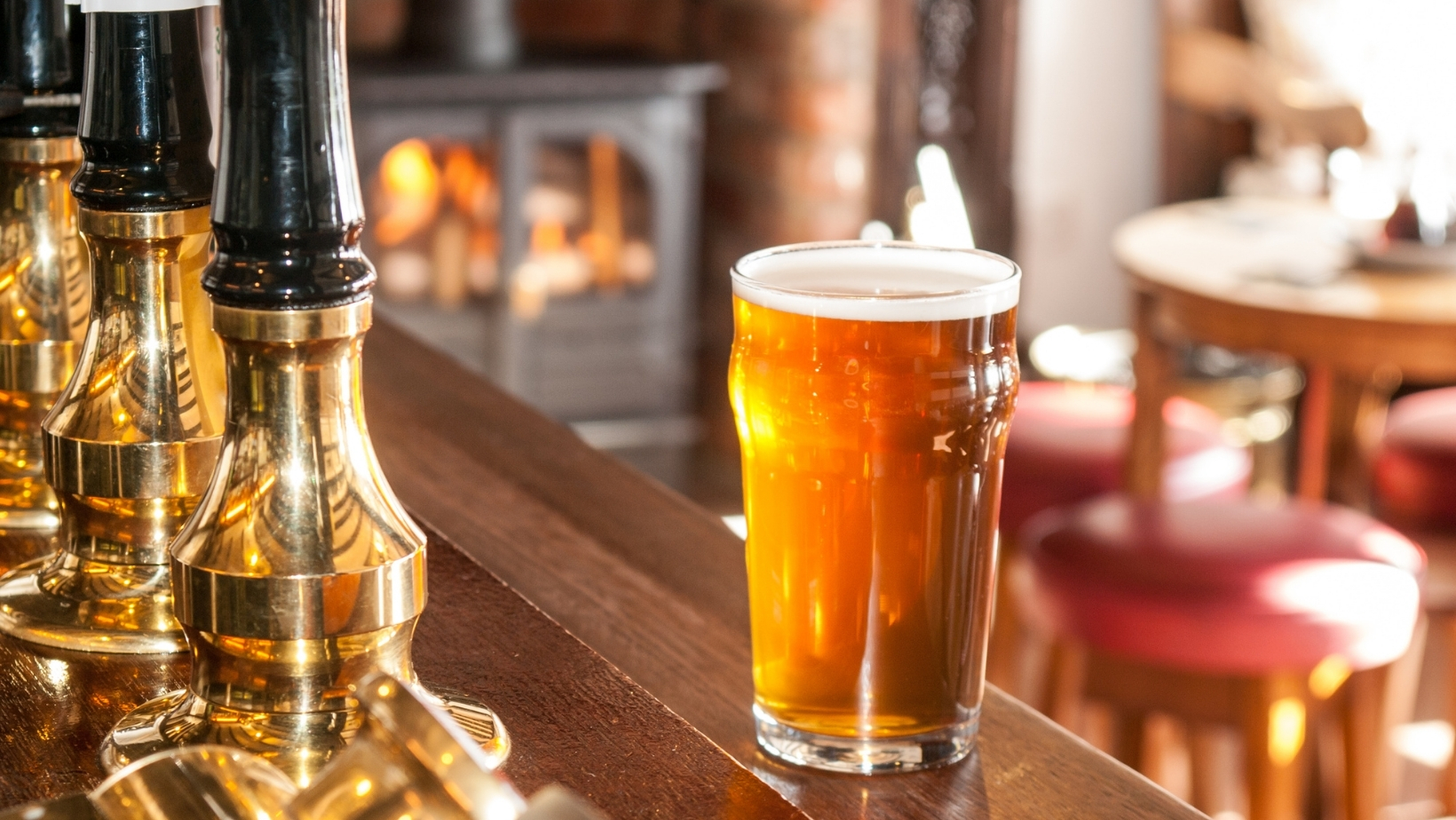 a picture of a pint glass on a pub bar